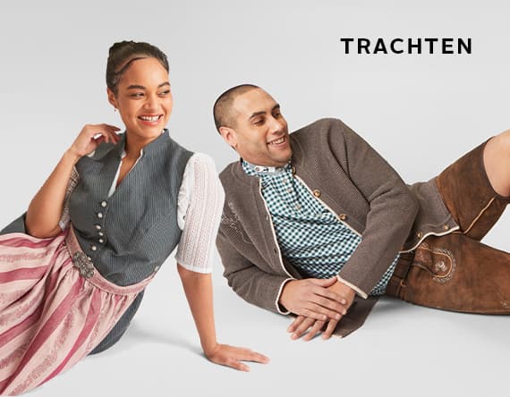 Trachten – Frau in traditionellem Dirndl und Mann in Lederhosen und Trachtenjacke posieren auf hellem Hintergrund.