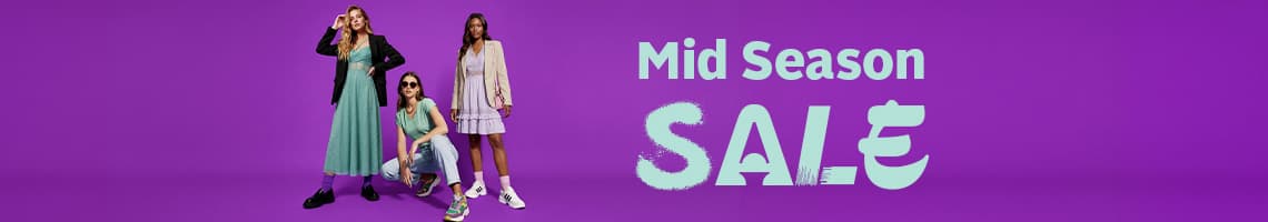 Mid Season Sale – drei Frauen in bunten Outfits posieren vor lila Hintergrund