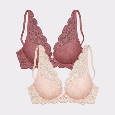 Zwei Spitzen-BHs mit gewelltem Rand, vorne ein heller Rosaton, dahinter ein BH in dunklem Rosa